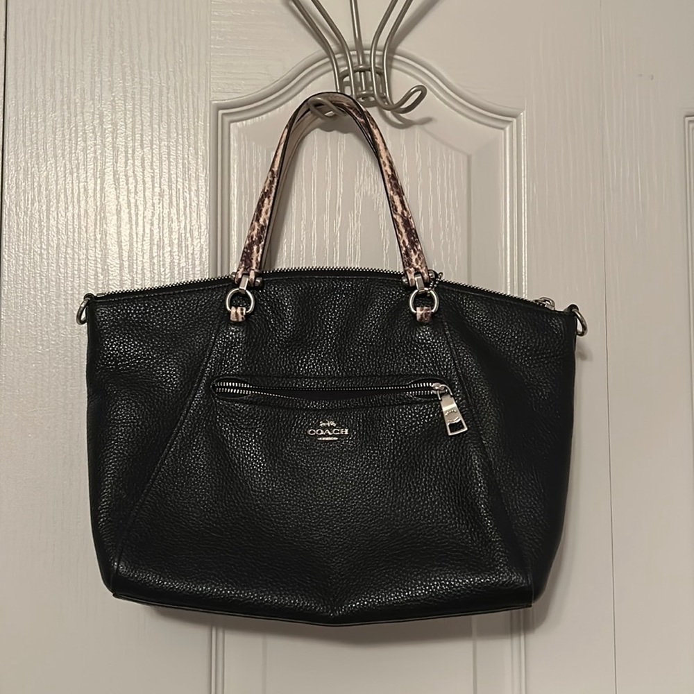Black Coach bag with patterned handle.